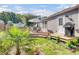 Beautiful backyard with a deck, grill and lush landscaping creates a serene outdoor living space at 100 Runnels Cv, Summerville, SC 29485