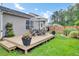 Spacious backyard featuring a well-maintained deck and lawn perfect for outdoor activities at 100 Runnels Cv, Summerville, SC 29485