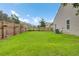 Well-maintained backyard featuring a large lawn, wooden fence, and plenty of space for recreation at 100 Runnels Cv, Summerville, SC 29485