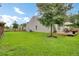 Expansive backyard featuring a mature tree, a deck and well-maintained lawn, perfect for outdoor enjoyment at 100 Runnels Cv, Summerville, SC 29485