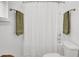 Bathroom with a shower curtain, towel racks with green towels, and a toilet at 100 Runnels Cv, Summerville, SC 29485