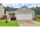 Charming single-Gathering home featuring a two-car garage, manicured lawn, and a welcoming entrance at 100 Runnels Cv, Summerville, SC 29485