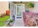 Inviting front porch with colorful landscaping, covered entrance, and stylish accents at 100 Runnels Cv, Summerville, SC 29485