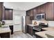 A modern kitchen with stainless steel appliances and dark wood cabinets at 100 Runnels Cv, Summerville, SC 29485