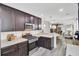 This kitchen features dark wood cabinets and stainless steel appliances with white walls at 100 Runnels Cv, Summerville, SC 29485