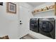 Laundry room featuring a full size washer and dryer, door, and shelving unit at 100 Runnels Cv, Summerville, SC 29485