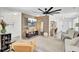 Spacious living room with a wood accent wall, ceiling fan, and ample seating at 100 Runnels Cv, Summerville, SC 29485