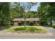Charming brick home featuring a well-manicured lawn, mature tree, and a welcoming front porch at 1002 Sea Gull Dr, Mount Pleasant, SC 29464