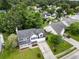 Aerial view of a home featuring a well-manicured lawn and a two-car garage, surrounded by lush greenery at 103 Retriever Ln, Goose Creek, SC 29445