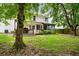 Backyard view featuring a deck, sun room, and well-maintained lawn at 103 Retriever Ln, Goose Creek, SC 29445