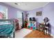 Bedroom featuring laminate wood floor, playful decorations, and bright purple walls at 103 Retriever Ln, Goose Creek, SC 29445