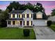 Charming two-story home with a well-manicured lawn, cozy front porch, and attached two-car garage at 103 Retriever Ln, Goose Creek, SC 29445