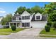 Traditional two-story home with black shutters, a well-kept lawn, and an attached two-car garage at 103 Retriever Ln, Goose Creek, SC 29445