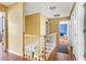 Upstairs hallway features wood floors and railing and several access doors at 103 Retriever Ln, Goose Creek, SC 29445
