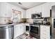Well-lit kitchen with white cabinets, stainless steel appliances, and ample counter space at 103 Retriever Ln, Goose Creek, SC 29445