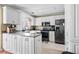 Bright kitchen featuring white cabinets, stainless steel appliances, and tile flooring at 103 Retriever Ln, Goose Creek, SC 29445