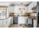 Cozy kitchen with white cabinets, stainless steel appliances, and tiled backsplash at 103 Retriever Ln, Goose Creek, SC 29445