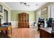 Living room with wood laminate flooring, light green walls, and bright, natural lighting at 103 Retriever Ln, Goose Creek, SC 29445