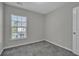 This bedroom features neutral walls, carpet floors, and a window providing natural light at 1034 Lexi Ct, Ladson, SC 29456