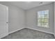 Well-lit bedroom with neutral walls, carpet, and a window with blinds at 1034 Lexi Ct, Ladson, SC 29456