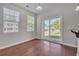 Bright living room with hardwood floors, large windows, and sliding glass door to backyard at 1034 Lexi Ct, Ladson, SC 29456