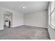 A living room featuring a window allowing for natural light and plush carpeting at 1034 Lexi Ct, Ladson, SC 29456