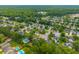 Residential neighborhood with tree-lined streets and various home styles, featuring a pool at 106 Brandy Ct, Summerville, SC 29485
