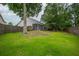 Spacious backyard featuring a large, lush lawn and a screened-in porch area at 106 Brandy Ct, Summerville, SC 29485