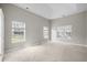 Light filled bedroom with plush carpeting, large windows, and ample natural light at 106 Brandy Ct, Summerville, SC 29485