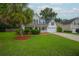 Well-manicured front lawn with a stately palm tree enhancing curb appeal at 106 Brandy Ct, Summerville, SC 29485