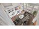 Aerial view of a staged living room boasting hardwood floors, fireplace, tall windows, and stylish decor at 106 Brandy Ct, Summerville, SC 29485