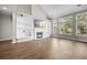 Spacious living room with vaulted ceilings, large windows, fireplace, and built-in shelving offering both style and functionality at 106 Brandy Ct, Summerville, SC 29485