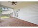 Relaxing screened-in porch featuring a brick floor and ceiling fan at 106 Brandy Ct, Summerville, SC 29485