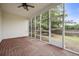 Relaxing screened-in porch featuring a brick floor and ceiling fan at 106 Brandy Ct, Summerville, SC 29485