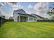 Expansive backyard view with a light blue home, dark wood fence, and well-manicured lawn, perfect for outdoor enjoyment at 111 Medford St, Summerville, SC 29486