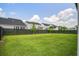Large, grassy backyard surrounded by a dark fence and mature trees, offering a private and serene outdoor space at 111 Medford St, Summerville, SC 29486