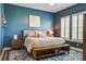 Comfortable bedroom featuring stylish blue walls, plush rug, and a large window with lots of natural light at 111 Medford St, Summerville, SC 29486