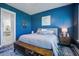 Comfortable bedroom featuring stylish blue walls, plush rug, and a large window with lots of natural light at 111 Medford St, Summerville, SC 29486