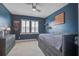 Stylish bedroom featuring blue walls, a ceiling fan, and ample storage with a dresser and nightstand at 111 Medford St, Summerville, SC 29486