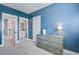 Blue bedroom featuring a dresser and entrances to an ensuite bathroom and another room at 111 Medford St, Summerville, SC 29486