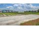 Community farm showcasing rows of crops, a greenhouse, and neatly organized plots in a charming neighborhood at 111 Medford St, Summerville, SC 29486