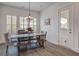 Dining area with wood table, upholstered chairs, bench seating, plantation shutters, and nautical decor at 111 Medford St, Summerville, SC 29486