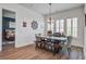 Dining area with wood table, upholstered chairs, bench seating, plantation shutters, and nautical decor at 111 Medford St, Summerville, SC 29486