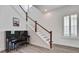 Bright foyer features hardwood stairs, a piano, and natural light from the window with white shutters at 111 Medford St, Summerville, SC 29486