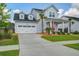 Well-maintained two-story home featuring a spacious driveway, landscaped yard, and a charming front porch area at 111 Medford St, Summerville, SC 29486