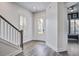 Bright foyer with hardwood floors, a staircase, and a front door view that leads to a living area at 111 Medford St, Summerville, SC 29486