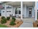Inviting front porch featuring a cozy swing, seating, and manicured landscaping at 111 Medford St, Summerville, SC 29486