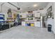 Spacious garage featuring epoxy floors, built-in cabinets, and a wall-mounted television for entertainment and organization at 111 Medford St, Summerville, SC 29486