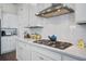 Close-up of the bright kitchen featuring white cabinets, quartz countertops, stainless steel appliances, and subway tile backsplash at 111 Medford St, Summerville, SC 29486