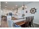 Spacious kitchen and dining area with modern white cabinets and stainless steel appliances at 111 Medford St, Summerville, SC 29486